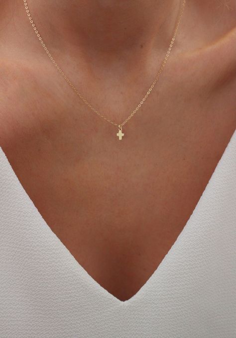 Tiny Cross Necklace | Dainty Gold Cross Necklace | Cross Choker Necklace |  Minimalist Cross Necklace | Simple Gold Cross | Gift for Her DETAILS: * PENDANT is 14k Gold Filled, measuring 4.5mm x 5mm * CHAIN is 14k Gold Filled * CLASP is 14k Gold Filled Model is wearing a 16 inch chain WHAT IS GOLD FILLED? Gold filled components contain 100+ times more real gold than gold plated components resulting in a very durable and long lasting product. Gold filled jewelry is tarnish resistant and a beautifu Small Cross Necklace, Dainty Gold Cross Necklace, Gold Dainty Necklace, Cross Necklace Simple, Cross Choker Necklace, Dainty Cross Necklace, Tiny Cross Necklace, Cross Choker, Tiny Cross