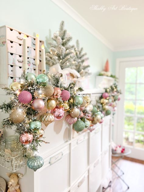 Pink Whimsical Christmas Tree, Christmas Boutique Crafts, Craft Room Christmas Tree, Pastel Christmas Mantle, Extra Christmas Decor, Christmas Decor Ideas For Boutique, Pink Christmas Display, Pink And Aqua Christmas Tree, Pink Christmas Fireplace Decor