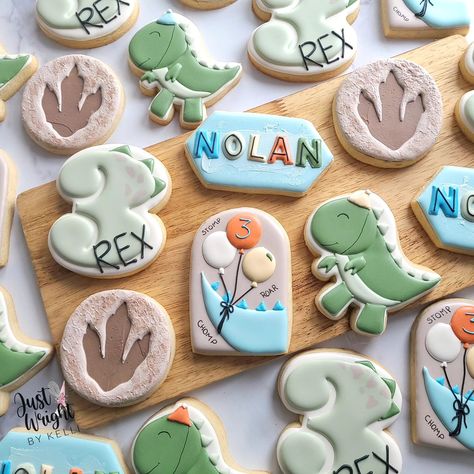 Stomp, Chomp, Roar! 🦖 Nolan's a THREE-REX and ready to party like a dinosaur with his playful birthday cookies. Happy Birthday Buddy. #threerex #birthdaysugarcookies #decoratedsugarcookies #t-rex #birthdaytreats #royalicingcookies #sugarcookiesofnstagram #balloons #dinoprint #letsparty #stompchomproar #southernNH First Birthday Dinosaur, Dino Cookies, Dinosaur Cookie, Dinosaur Birthday Theme, Dinosaur Birthday Party Decorations, Royal Iced Cookies, Boys First Birthday Party Ideas, Dinosaur Cookies, Birthday Dinosaur