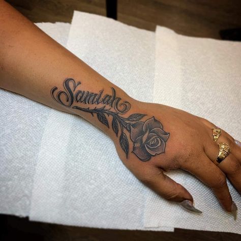 Flower Hand Tattoo With Name, Rip Hand Tattoos For Women, Hand Tattoos For Women Names, Name Tattoos For Girlfriend, Tatoos Woman Hand Name, Tattoo With Moms Name, Word Sleeve Tattoos For Women, Placement For Name Tattoos, Forearm Name Tattoo Women