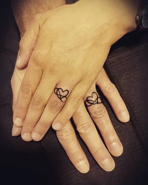 60 Best Love Tattoos that will Definitely Melt Your Heart in 2021 Infinity Ring Tattoos, Heart Ring Tattoo, Infinity Ring Tattoo, Wedding Ring Finger Tattoos, Heart With Infinity Tattoo, Infinity Couple Tattoos, Heart Tattoo On Finger, Ring Tattoo Designs, Wedding Band Tattoo