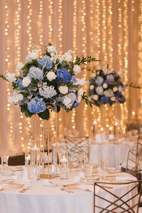 Elegant centerpieces starring blue hydrangeas & crisp white roses for a luxe celebration at the Grand Hyatt 💙 Wedding Centerpieces Blue Hydrangea, Blue And White Roses Centerpieces, Blue And White Centerpieces For Party, Centerpieces With Lavender, Light Blue Centerpieces, Blue And White Wedding Centerpieces, Blue Wedding Table Settings, Blue Wedding Reception Decor, Navy Wedding Centerpieces