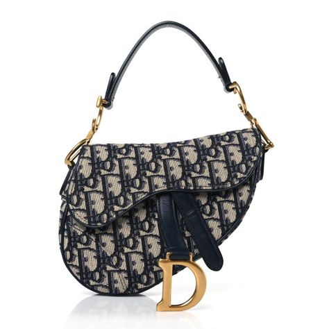 This is an authentic CHRISTIAN DIOR Oblique Mini Saddle Bag in Blue. The chic bag is crafted of navy on beige Dior monogram canvas. The bag features a short leather shoulder strap with a polished brass "C" and "D" anchors on either end of the handle, and a prominent hanging Dior "D" charm. The flap opens to a beige fabric interior. Christian Dior Shoulder Bag, Dior Shoulder Bag Outfit, Navy Blue Designer Bag, Cute Bags Designer, Rare Dior Bag, Blue Dior Bag, Dior Bag Saddle, Aesthetic Purses, Dior Mini Bag