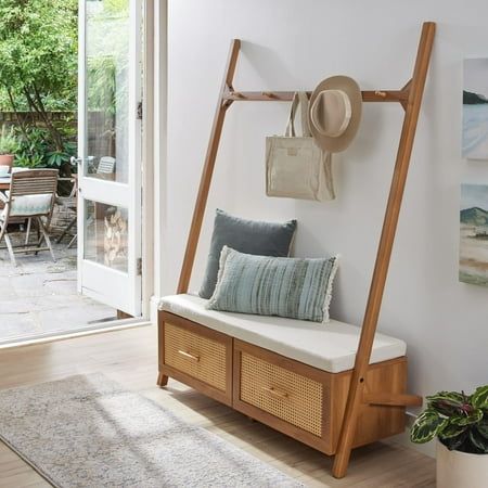 Streamline your entryway with the Better Homes & Gardens Springwood Entryway Tree. Crafted from laminated particleboard, this bench exudes a trendy vibe with its charming woodgrain finish and rattan drawer fronts. Utilize the five chunky wood knobs for hanging coats, scarves, and bags, while the two deep drawers effortlessly organize shoes and accessories. The leaning ladder design, coupled with minimalistic features and an open back, enhances the overall aesthetic. Take a seat on the padded bench while slipping on your shoes. For added stability, the entryway hall tree includes a wall anchoring kit. Delivered flat to your door, assembly is required upon arrival, and we recommend the hands of two adults for the task. Assembled dimensions: 68.7"H x 54"W x 18.34"D. Color: Black. Entryway Bench And Storage, Coat Rack Bedroom Aesthetic, Modern Entryway Furniture, Mid Century Modern Hall Tree, Mail Station Entryway, Entryway Tree Bench, Eclectic Entryway Table, Shoe Rack Decor Entryway, Small Entry Drop Zone