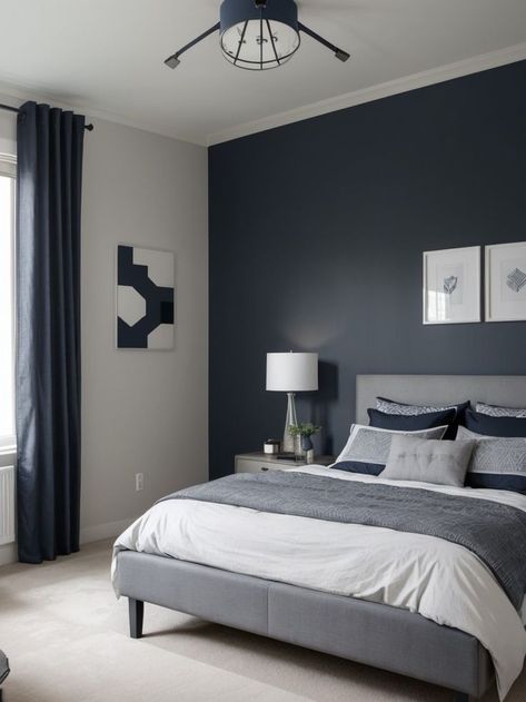 Create a stylish and sophisticated boys bedroom with a combination of grey and navy. Use a navy blue accent wall as a focal point, complemented by grey bedding and curtains for a modern and masculine look. Complete the design with industrial-style light fixtures and geometric patterns for added visual interest. Blue Teen Bedrooms, Navy Blue Accent Wall, Boys Bedroom Grey, Grey Boys Rooms, Navy Blue Rooms, Blue And Grey Bedding, Blue Accent Wall, Blue Boys Bedroom, Light Gray Bedroom