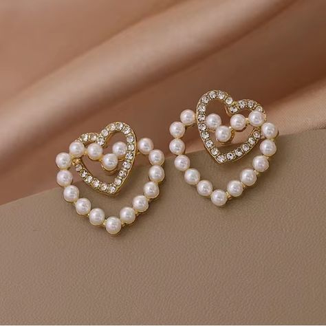 Beautiful Faux Pearl Heart Entwined With A Simulated Diamond Heart On Gold Toned Stud Earrings. Very Unique Setting Gives A Feminine Romantic Look. See My Other Listings For More Jewelry. Bundle To Save On Shipping. #E176 Heart Pearl Earrings, Fox Earrings, Bottle Earrings, Faux Pearl Earrings, Heart Dangle Earrings, Sparkle Earrings, Rhinestone Heart, Women's Jewelry And Accessories, Double Heart