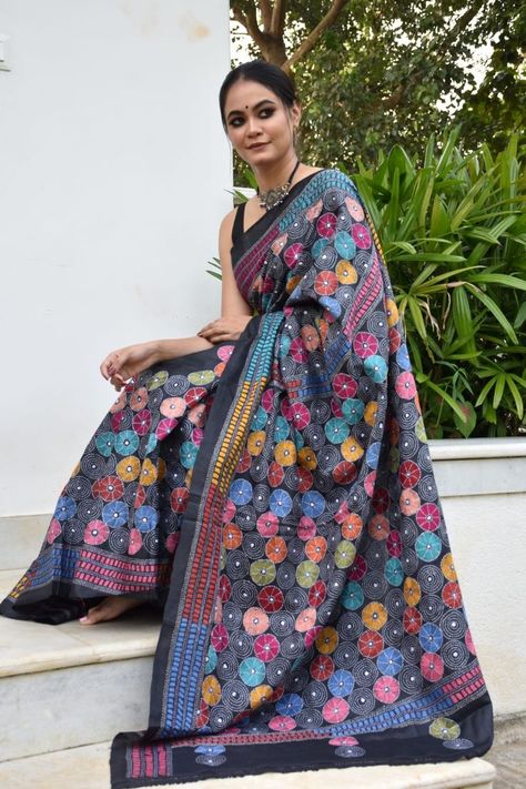 Each saree tells a story, a story of countless hours of dedicated work a passionate affair of emotions. Dazzle the world in this beautiful black saree with multicolored kantha work. It has colourful floral motifs to make the saree look stand out. You can't miss out on this if you love Black! Katha Work Saree, Saree Designer Blouse, Kantha Work Sarees, Stitch Saree, Embroidery Shirts, Latest Silk Sarees, Kantha Sarees, Saree Designer, Kantha Embroidery