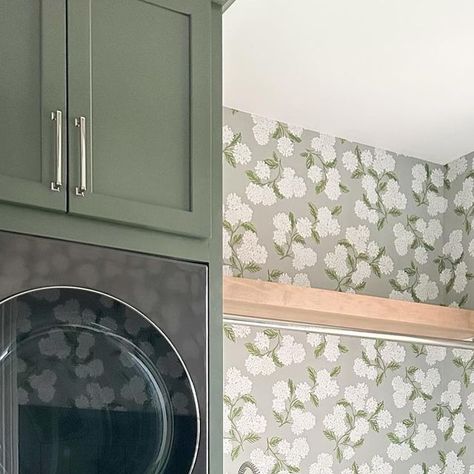 Britney Fedricks on Instagram: "Laundry Rooms should not only be functional, but fun! Stacking the washer and dryer gave us extra countertop space for folding at our Carrollton project 🧺 And this @riflepaperco wallpaper paired with the green cabinets… yes please 🙋🏻‍♀️  - #laundryroom #laundryroomgoals #lgappliances #lifesgood #riflepaperco #wallpaper  Green Cabinets, Laundry Room, Stacked Washer Dryer, Gray Floor Tile, Floral Wallpaper" Laundry Room Makeover Wallpaper, Green Cabinets In Laundry Room, Riflepaperco Wallpaper, Green Cabinets Laundry, Laundry Room Stacked, Green Cabinets Laundry Room, Wallpaper In Laundry Room, Cabinets Laundry Room, Green Laundry Room