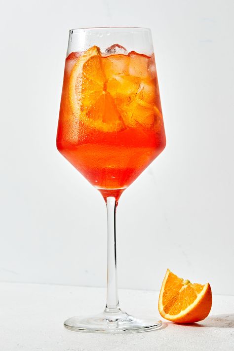 an Aperol Spritz in a stemmed glass over ice with an orange slice as garnish and an orange slice on the counter beside it Easy Mint Julep Recipe, Frozen Pina Colada, Julep Recipe, Aperol Spritz Recipe, Best Summer Cocktails, Spritz Recipe, Pina Colada Recipe, The Modern Proper, Modern Proper