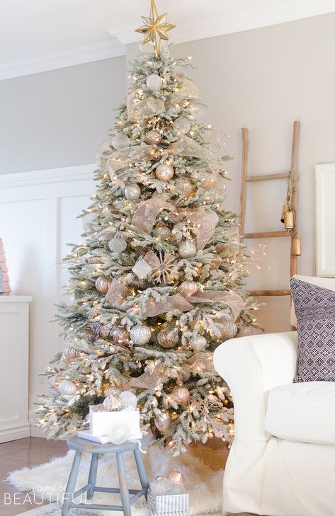 A snowy flocked Christmas tree decorated in silver and rose gold adds a big dose of holiday cheer to this modern farmhouse living room Rose Gold Christmas Decorations, Flocked Christmas Tree, Snowy Christmas Tree, Silver Christmas Decorations, Flocked Christmas Trees Decorated, Rose Gold Christmas, Farmhouse Christmas Tree, A White Christmas, Gold Christmas Decorations