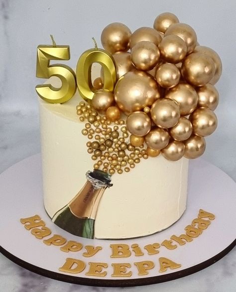 Champagne bottle cake decorated with Golden faux balls 50th Cake Designs Birthday, Champagne Bottle Cake Ideas, Birthday Cake With Balls, Champagne Cake Ideas, Mens 70th Birthday Cake, Birthday Cake With Champagne Bottle, Champagne Theme Cake, 50th Birthday Cake For Women Simple, Cake With Balls Decoration