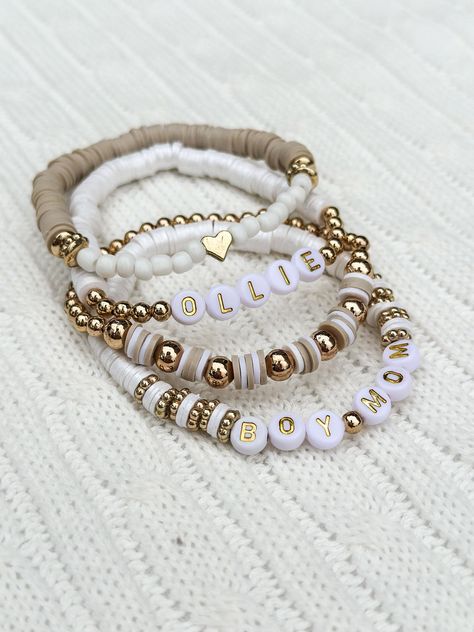 Complete your look with this trendy, neutral set of personalized stacking bracelets.  This is the perfect set to dress up your outfit with your loved ones names or meaningful words.  Choose how many name/word bracelets you would like in your set & please list the names/words you would like on the bracelet in the personalization section. I will message for any further questions!  *All bracelets come on a standard 7 inch, adult bracelet on high quality, stretchy elastic cord. If you need a different size, please specify in the personalization section.  *Over stretching and rough handling can cause bracelets to break.  Handle bracelets with care. Keep away from water, lotions and sprays. **Exchanges not offered on custom bracelets. *Buyer assumes ALL liability. Homemade Bead Bracelet Ideas, Most Popular Beaded Bracelets, Diy Stackable Bracelets, Stacked Bracelet Ideas, Clay Bracelet Stack, Neutral Bracelet Stacks, Diy Clay Bead Bracelet Ideas, Trending Bracelets 2024, Neutral Clay Bead Bracelets