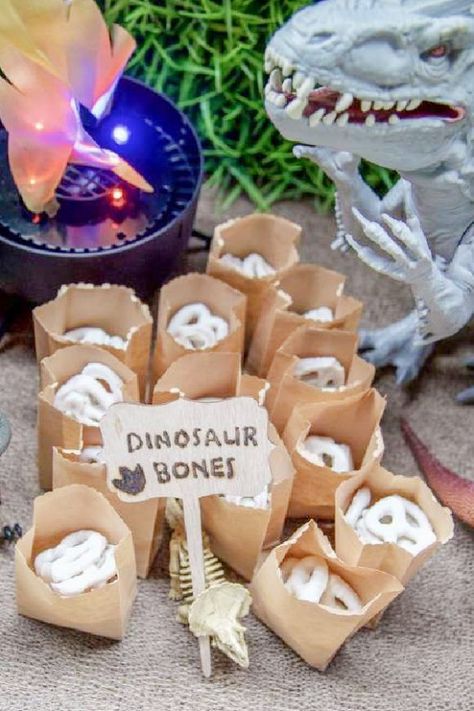 3 Rex Birthday Party Food Ideas, Dino Food Ideas Themed Parties, Cute Dinosaur Party Decorations, Dino And Unicorn Party Decorations, Dinosaur Bones Pretzels, Dino Themed Treats, Dinosaur Treat Table Ideas, Dino Food Party, T Rex Party Decorations