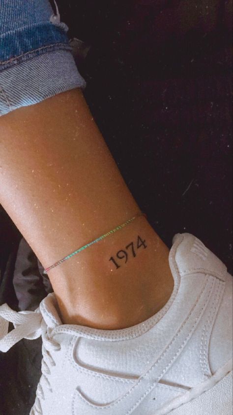 Year Ankle Tattoos For Women, Moms Birth Year Tattoo, Floral Date Tattoo, 777 Ankle Tattoo, Year Date Tattoo Ideas, Birth Year Tattoo Placement, Date Tattoo Ideas Women, Birth Date Tattoos For Women, Gimli Tattoo