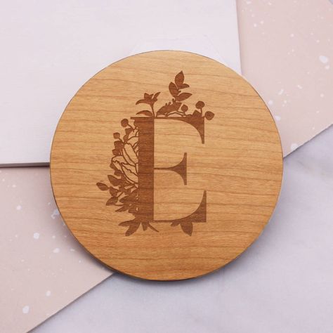 This beautiful wooden coaster is etched with a botanical initial design, perfect for a gift to a loved one or teacher.You can enter in one initial or number into the box provided.This wooden coaster is a practical and sentimental gift which can be cherished for years to come.The coaster is laser cut from sustainably sourced cherry wood veneer and the detail is laser etched onto the surface. The veneered finish makes this a strong and durable coaster.The coaster is just under 9cm in diameter ... Initial Design Ideas, Wooden Coaster Ideas, Pyrography Coasters, Personalized Wood Coasters, Woodburning Ideas, Pyrography Designs, Laser Crafts, Workshop Projects, Coaster Ideas