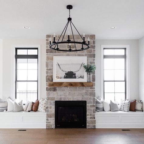 A pair of tall, double-hung windows helps emphasize the design symmetry in this farmhouse living room. Black frames complement the lighting fixture—even the dark fireplace! Design Camino, Farmhouse Room, Farmhouse Fireplace, Fireplace Remodel, Fireplace Ideas, Home Fireplace, Fireplace Makeover, Design Del Prodotto, Living Room With Fireplace