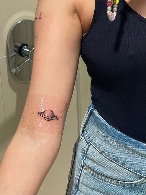 saturn tattoo planet space Saturn Aquarius Tattoo, Saturn And The Moon Tattoo, Cute Saturn Tattoos, Saturn Planet Tattoo, Moon And Saturn Tattoo Taylor Swift, Small Saturn Tattoo, Saturn Tattoo Minimalist, Small Planet Tattoo, Moon And Saturn Tattoo