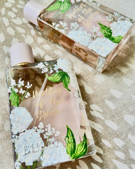 You’ve never seen a prettier MOB and MOG gift🤍 Painted on the brides signature wedding scent, these custom painted perfume bottles are the perfect addition to each mom’s vanities. Serving as a beautiful reminder of the day their children said “I do” and two families became one💍 Mother of the bride gift | mother of the groom gift | wedding morning gifts | wedding day gift ideas | gift for bride | gift for bridesmaids | wedding day details | custom gift ideas | unique gift ideas | austin artis... Bridesmaid Gifts From Bride Day Of, Wedding Morning Gifts, Mob Gift, Wedding Scent, Bridesmaid Gifts From Bride, Wedding Perfume, Mother Of The Groom Gift, Wedding Day Details, Mother Of The Bride Gift