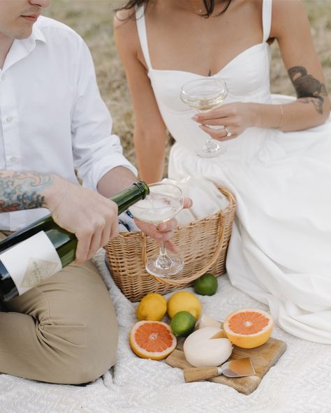 Picnic date at your engagement session? I’ll be there! 🍊🥂🍋 Engagement Photos Picnic Ideas, Pre Wedding Picnic Photoshoot, Picnic Prenup Photoshoot, Cheers Engagement Photos, Picnic Couple Ideas, Engagement Picnic Photos, Engagement Photo Picnic, Beach Picnic Engagement Photos, Picnic Prewedding