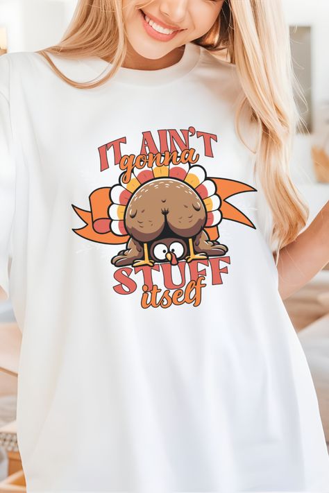 It’s that time of year again—time to eat until you can’t move and laugh until your sides hurt. This hilarious "It Ain't Gonna Stuff Itself" Thanksgiving shirt is perfect for anyone who’s serious about two things: turkey and good times. Featuring a cheeky turkey with its backside front and center, this shirt makes it clear: the turkey isn’t going to stuff itself, and neither are you! Turkey Shirt Ideas, Thanksgiving Funny Shirts, Thanksgiving Shirt Ideas, Turkey Meme, Funny Thanksgiving Shirts, Turkey Shirts, Turkey Dinner, Thanksgiving Shirt, Time To Eat