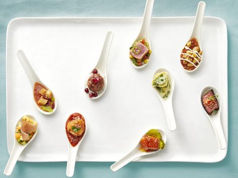 Whether you're getting married or throwing a fancy dinner party, one-bite appetizers served on a spoon are the way to go! From spicy hot chicken to elegant proscuitto and melon, here are nine ways to take the popular internet trend and make it your very own! Mini Appetizers On A Spoon, Appetizers In Spoons, Appetizer Spoons Ideas, Soup Spoon Appetizers, Canape Spoon Recipes, Appetizers Served On Spoons, Appetizers On Spoons, Tasting Spoon Appetizers, Spoon Canapes