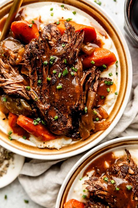 You don't need an expensive cut of beef to make a restaurant-worthy meal – this Red Wine Braised Beef recipe is proof! Slowly simmer beef chuck roast with red wine, vegetables, & herbs until it transforms into a succulent centerpiece complete with a built-in red wine sauce. Serve with creamy mashed potatoes for the best cozy dinner! (Slow cooker/Crockpot & Instant Pot directions provided.) #redwinebraisedbeef #redwinebeefroast #braisedbeef ##braisedbeefroast #beefroast #beefrecipes #dinnerideas Red Wine Beef Roast, Cooking Chuck Roast, Roast With Red Wine, Red Wine Braised Beef, Wine Braised Beef, Braised Beef Recipes, Chuck Roast Recipes, Best Pot Roast, Succulent Centerpiece