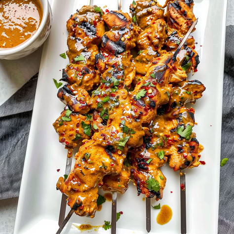 Fire up the grill with these Thai Curry Chicken Skewers! Juicy, flavorful chicken paired with a creamy coconut peanut sauce makes the perfect dish for any BBQ or dinner. Ready in no time and packed with exotic Thai flavors! Chicken Skewers Dinner, Thai Curry Chicken Skewers, Thai Chicken Skewers With Peanut Sauce, Thai Chicken Skewers Grilled, Grilled Thai Coconut Chicken Skewers, Thai Coconut Chicken Skewers, Thai Appetizers For Party, Thai Food Appetizers, Thai Chicken Tenders