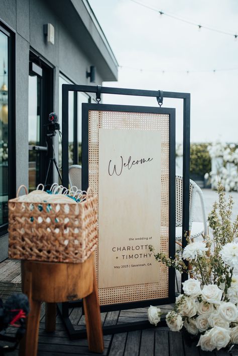 Black and rattan wood wedding welcome sign for a rooftop celebration in Savannah, Georgia. Planning by Plume Events and photo by 7Nine Photography. Rattan Wedding Invitation, Rattan Signage, Rattan Seating Chart, Wood Wedding Signage, Unique Wedding Welcome Sign Ideas, Rattan Wedding Decor, Unique Welcome Signs Wedding, Decor Rental Business, Unique Wedding Welcome Sign