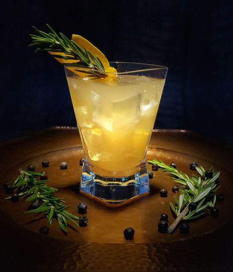 At the center of a rustic copper platter sits a tall glass of this lovely Grapefruit & Evergreen Mocktail. Sprigs of  fresh rosemary and dried juniper berries are casually strewn across the base of the platter. Light bounces off the ice in the glass of this crisp, fresh and inviting mocktail. Black Walnut Bitters, Walnut Bitters, Tea Mocktail, Cup Of Kindness, Juniper Berries, Rosemary Sprigs, Sugar Crystals, Juniper Berry, Mocktail Recipe