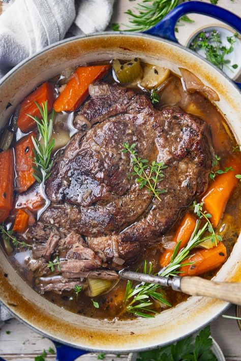 Tender and juicy, this Dutch oven pot roast transforms an affordable cut of meat into a delicious comfort food dinner. The beef slowly bakes with potatoes and carrots for an easy one pot meal. Your whole family will love this classic Sunday supper! Roast In Dutch Oven, Sunday Soup, Dutch Oven Pot Roast, Recipes Hamburger, Oven Pot Roast, Leftover Pot Roast, Chuck Roast Recipes, The Seasoned Mom, Camping Dinners