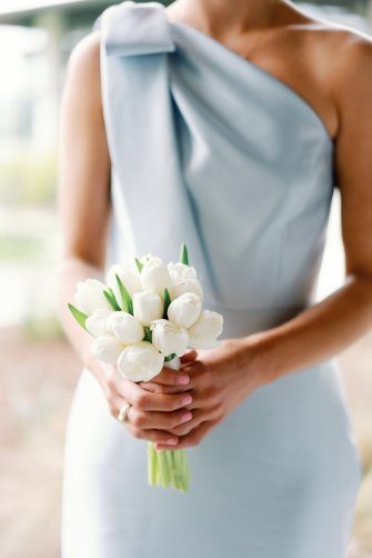 Posey bouquet of white tulips. Small Wedding Bouquet Simple White, Small White Tulip Bouquet, Bridesmaid Bouquet Blue Dress, Wedding Bouquets Bride Tulips, Bridesmaid Lily Bouquet, Hydrangea And Tulip Bouquet, Petite Bridesmaid Bouquet, Small White Bridesmaid Bouquet, Bridesmaid Posey