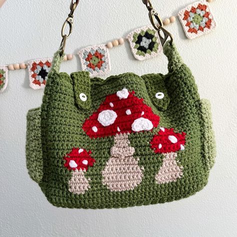 Apparently I haven’t posted the finished version of this bag! It took me way too long to finish it, but it came pretty dang cute. It has adjustable straps, multiple pockets, and the button closures on the front. If you’re at all interested in buying, DM me or head to Etsy or Depop to buy! #mushroompurse #munshroombag #cottagecore #cottagecorecrochet #crochetbag #crochetpurse Crochet Mushroom Purse, Mushroom Purse, Sling Bag Crochet, Green Cottagecore, Cottagecore Bag, Cottagecore Mushroom, Crossbody Bag Pattern, Crochet Mushroom, Bag Pattern Free