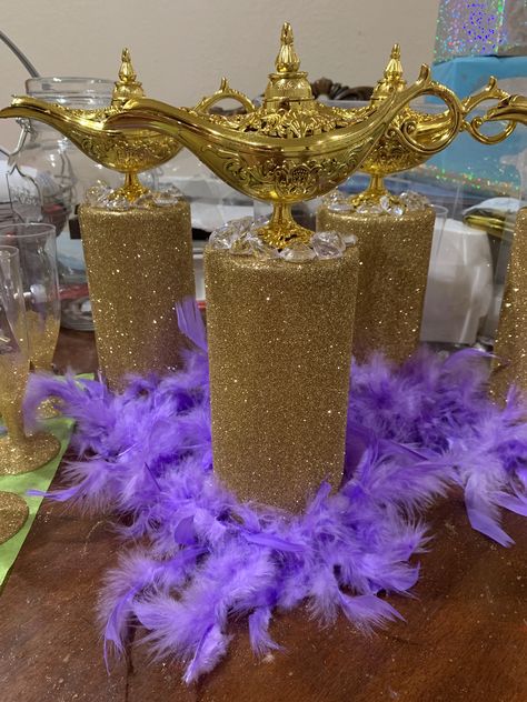 Do it yourself Aladdin glitter gold jasmine feather lamp centerpiece genie Jasmine Birthday Table Decorations, Arabian Nights Table Decorations, Genie Theme Party, Princess Jasmine Centerpieces, Genie Lamp Centerpiece Ideas, Jazmine Quinceanera Theme, Aladdin Theme Party Food, Aladdin Wedding Centerpieces, Alladin Themed Wedding