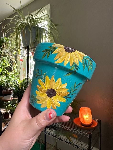 Enjoy this bright and cheery sunflower hand painted plant pot! This pot was hand painted by me and made with so much love! This pot has been sealed before acrylic painting and after, so it will hold up for a long I recommend using this as an indoor pot or under a covered porch. Use pot outdoors at your own risk. If you need to clean the pot, just wipe off with a wet rag. May your plant have an ever bearing life in this sweet pot!  What You Get: 4inx4in  hand painted orange pot with a drainage ho Sunflower Pot Painting, Sunflower Terra Cotta Pot, Plant Pots Painting, Sunflower Home Decor Diy, Terracotta Pot Painted, Decorated Pots, Painting On Pots, Paint Pots Ideas, Clay Pot Art