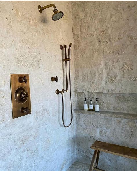 This white stone wall is able to produce a natural shower decoration and a rustic touch to the entire room. The touch of gold on this shower faucet can make your shower room decoration more charming. White Stone Shower Wall from @churchstreetdesigns #showerwallmaterials #bathroomrenovation Showers With Stone Walls, Stone In Shower Wall, Stone Walls Bathroom, White Stone Shower Ideas, Natural Stone In Bathroom, Stone Shower Ideas Rustic, Rustic White Wall, Natural Stone Bathroom Ideas Shower Tiles, Mediterranean Stone Wall