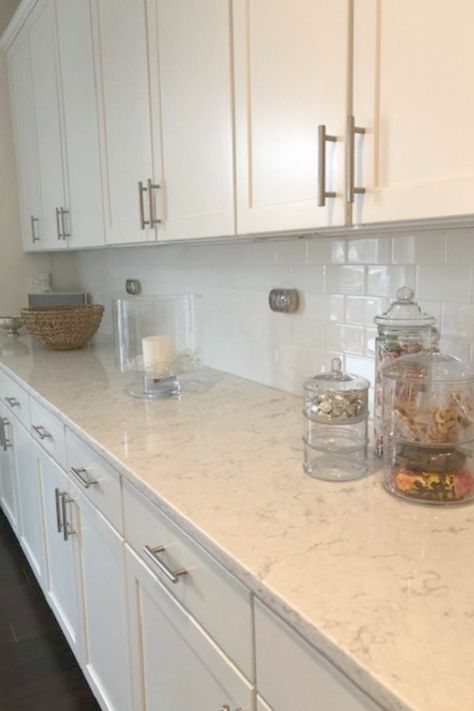 White kitchen with Viatera Minuet quartz countertops - Hello Lovely Studio. White Kitchen Cabinets With Beige Quartz, White Cabinets With White Quartz Counter, Kitchen Countertops With White Cabinets Quartz Carrara Marble, White Counter Tops With White Cabinets, Quartz Counter Tops With White Cabinets, White Kitchen Counters Quartz, Ventina Quartz Countertops, Viatera Karis Quartz Countertops, Short Quartz Backsplash