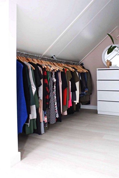 a cool attic closet wiht a pink accent wall, a white dresser, a rail with clothes is a very smart idea for a small home with an attic Slanted Ceiling Closet, Attic Closet Ideas, Small Attic Room Ideas, Pink Accent Wall, Loft Closet, Small Attic Room, Pink Accent Walls, Attic Bedroom Storage, Clothes Shelves