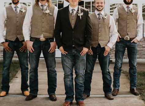 Dark brown jacket, tan vests, off white shirts with dark jeans and boots Groomsmen Jeans And White Shirt, Groomsman Western Attire, Groomsman Jeans And Vest, Tan Groomsmen Attire Rustic, Groom With Jeans And Vest, Country Men Wedding Attire, Brown Vest Wedding Groomsmen, Mens Wedding Vest And Jeans, Western Wedding Vests For Men