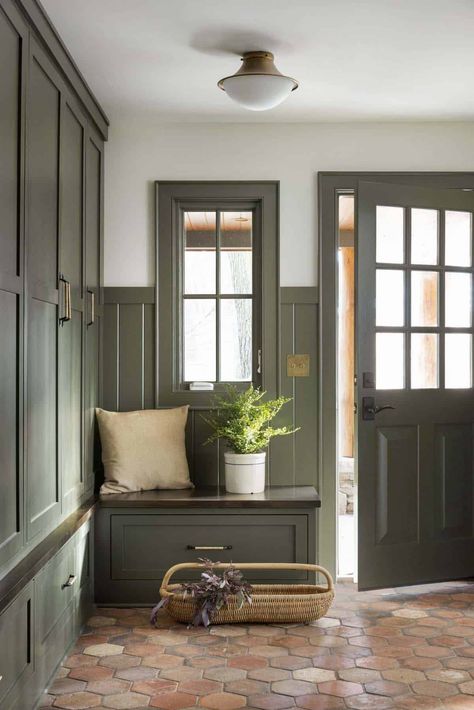 Inside a warm and inviting Minnesota lake house remodel on a woodsy setting English Boot Room Country Houses, Green Cabinet Mudroom, New England Mudroom, Green Mud Room Ideas, Modern Arts And Crafts Interior Design, Craftsman Home Remodel, Mudroom Door Interior, Olive Green Mudroom, Old House Mudroom