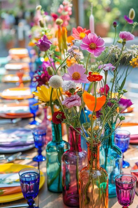 20 Beautiful Wildflower Centerpieces For Any Event • Coloured Glass Wedding, Colorful Bud Vases Wedding Centerpiece, Colourful Bud Vases, Flower Power Decorations, Wedding Round Table Settings, Colourful Wedding Table, Wild Flower Wedding, Flower Power Party, Bud Vases Wedding