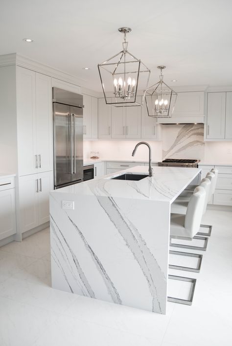 One of my favourite projects. This all white kitchen features Cambria Quartz Brittanicca countertops and a large island with waterfall edges. #brittanicca #whitekitchen #kitchendesign #waterfallisland #waterfalledge #whitekitchenideas #allwhitekitchen Kitchen Island Waterfall Edge, Waterfall Countertop Island, Quartz Waterfall Island, Townhome Design, Cambria Brittanicca, Waterfall Countertop, Kitchen Loft, Waterfall Island, Cambria Quartz