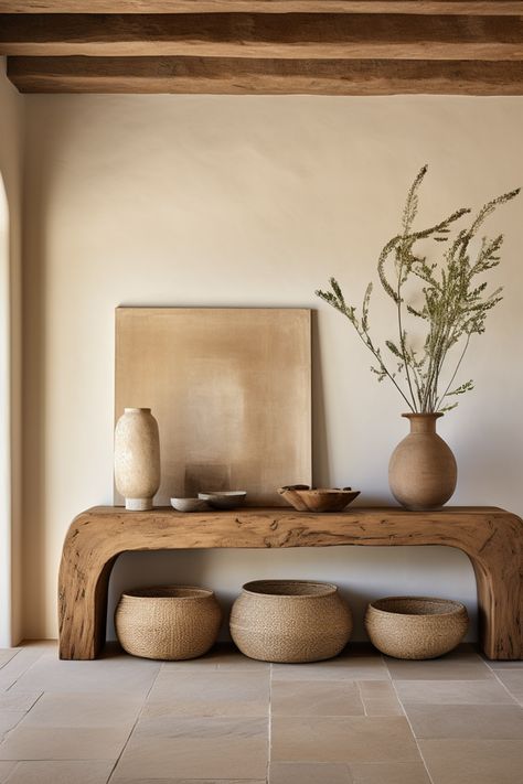 Discover curated charm in our entryway oasis, adorned with a rustic wooden console table, decorative baskets, and minimalist ceramics. Embracing the essence of southern countryside living, this space weaves earthy tones, emotive lighting, and the quaint allure of cottagecore. #CuratedCharm #RusticEntryway #SouthernAppeal #MinimalistDecor #CottagecoreInspiration #EarthTonePalette #DecorativeStools #EmotiveLighting #CountryLiving #HomeDesign Earthy Tones Home Interior, Entryway Organic Modern, Organic Earthy Interiors, Rustic Organic Home Decor, Modern Organic Entryway Ideas, Boho Natural Living Room, Organic Modern Entry, Organic Design Interior, Earthy Tones Interior