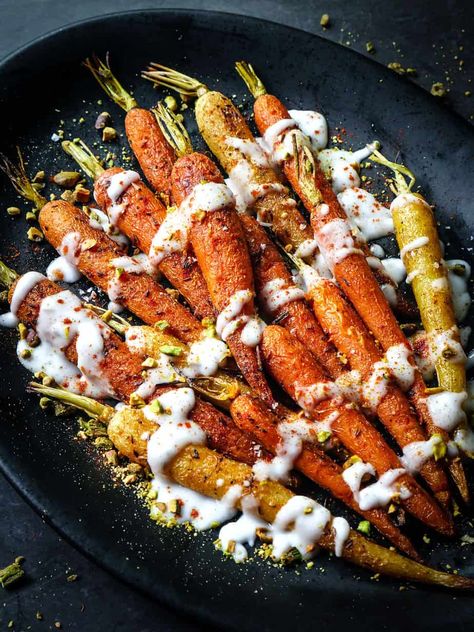 Close up image of Cumin Roasted Carrots with Yogurt and Pistachios on a black platter. Roasted Carrots With Pistachios, Cumin Carrots, Cumin Roasted Carrots, Fresh Veggie Recipes, Fancy School, Cumin Recipes, Roasted Carrot Salad, Bunny Food, Roasted Carrots Recipe