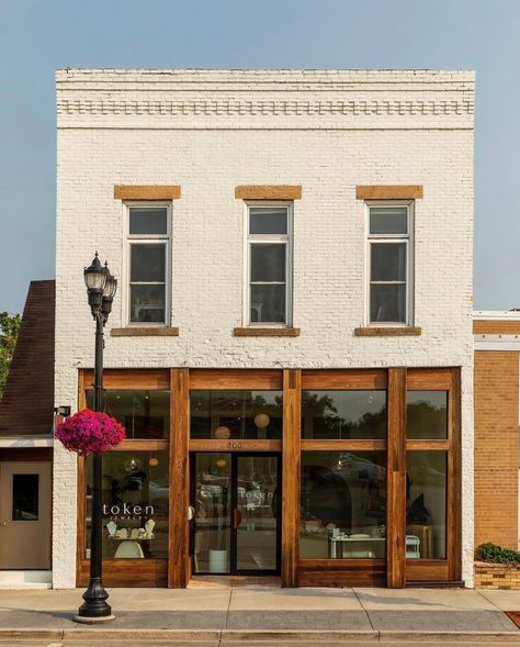 It's a perfect day to visit our beautiful shop! Did you know our space was designed using the sun as inspiration?🌞 We were lucky enough to work with @shelterdesigns to bring our vision to life. Token even won 1st place at the Midwest Home Design Awards gala for Retail Interior Design!✨ City Store Fronts, Quaint Shops Store Fronts, Store Door Design Shop Fronts, Commercial Retail Architecture, Historic Commercial Building Exterior, Retail Store Exterior Design, Furniture Store Exterior, Cute Shop Exterior, Painted Brick Store Fronts