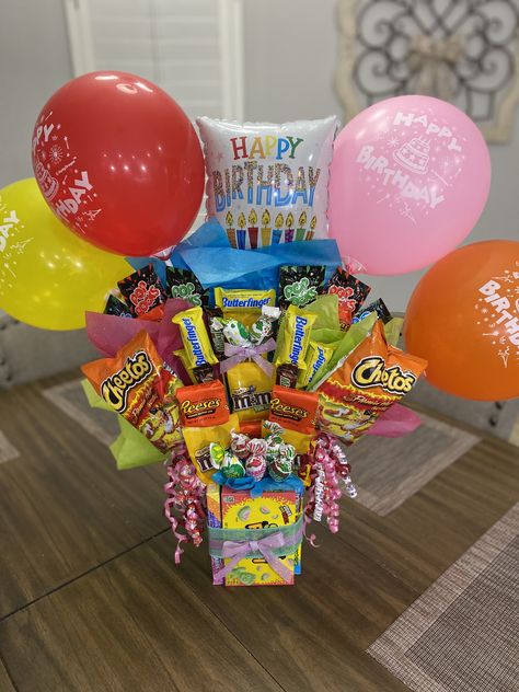 Dollar Tree materials. Glued on candies with wooden skewers Candy Bucket Ideas Gift Baskets, Diy Candy Birthday Gifts, Candy Baskets Ideas, Birthday Gifts From Dollar Tree, Candy Birthday Basket, Kids Candy Bouquets, Candy Birthday Gift Ideas, Dollar Tree Birthday Basket, Snack Birthday Gift Ideas