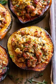 This savory stuffed acorn squash is so delicious it’s addicting! A sausage and cauliflower rice stuffing is seasoned with lots of fresh herbs and served toasty in roasted acorn squash bowls. Perfect as a holiday side dish or an anytime meal. Paleo, Whole30, and low in carbs. Savory Stuffed Acorn Squash, Acorn Sausage Squash, Acorn Squash Bowl Recipes, Acorn Squash With Stuffing, Sausage Acorn Squash Recipes, Sausage Stuffed Acorn Squash Recipes, Stuffed Acorn Squash Recipes, Cauliflower Stuffing, Acorn Squash Stuffed