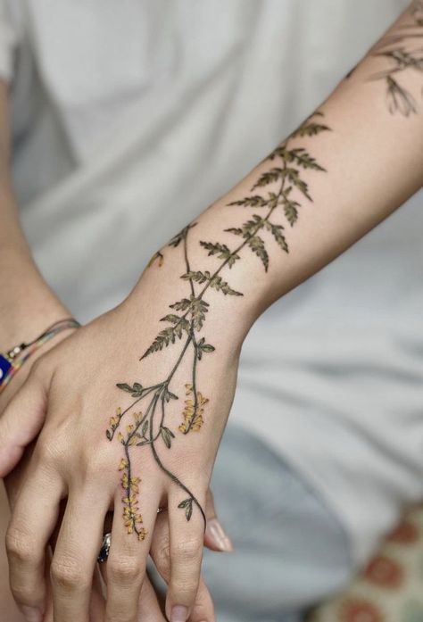 Nature's poetry etched in ink: Anna Botyk's botanical tattoo designs tell a story of blossoms, leaves, and delicate details. 🌺💉 Join me in exploring the enchantment of these nature-inspired masterpieces. Herb Sleeve Tattoo, Hand Fern Tattoo, Climbing Flower Tattoo, Green Vine Tattoos For Women, Vines On Hand Tattoo, Nature Hand Tattoos For Women, Leaf And Vine Tattoos, Vegetation Tattoo, Green Thumb Tattoo