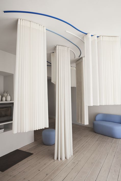 Blue and white ceiling mounted curtain tracks carrying white curtains. Curtain Room Dividers, Ceiling Mounted Curtains, Room Division, How To Hang Curtains, Curtain Divider, Interior Design Curtains, Curtain Room Divider, Curtain Tracks, Hang Curtains