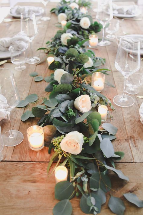 How to make a real eucalyptus table garland using a faux garland as a base. By tucking real branches into the faux garland you save time and money Decorating With Eucalyptus Garland, Simple Wedding Table Decor Long Tables, Eucalyptus Table Decor, Diy Eucalyptus Garland, Diy Eucalyptus, Faux Garland, Eucalyptus Centerpiece, Wedding Table Garland, Tablescapes Spring