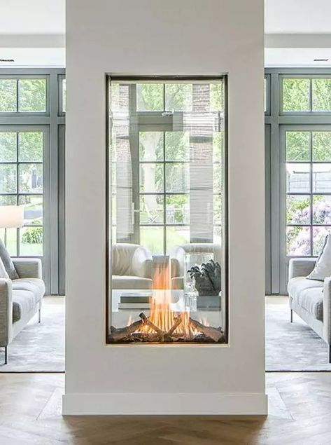 a two sided fireplace with glass will provide two spaces with a beautiful fire look and with coziness and chic Modern Glass Fireplace Ideas, Glass Fireplace Ideas, Fireplace Under Window, Enclosed Fireplace, Two Way Fireplace, 2 Sided Fireplace, Fireplace In Kitchen, Fireplace Between Windows, Through Fireplace